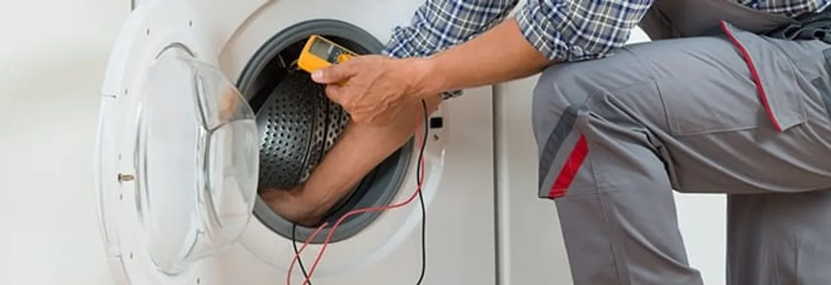 Dryer repair technician inspecting and repairing a clothes dryer in Duluth, MN
